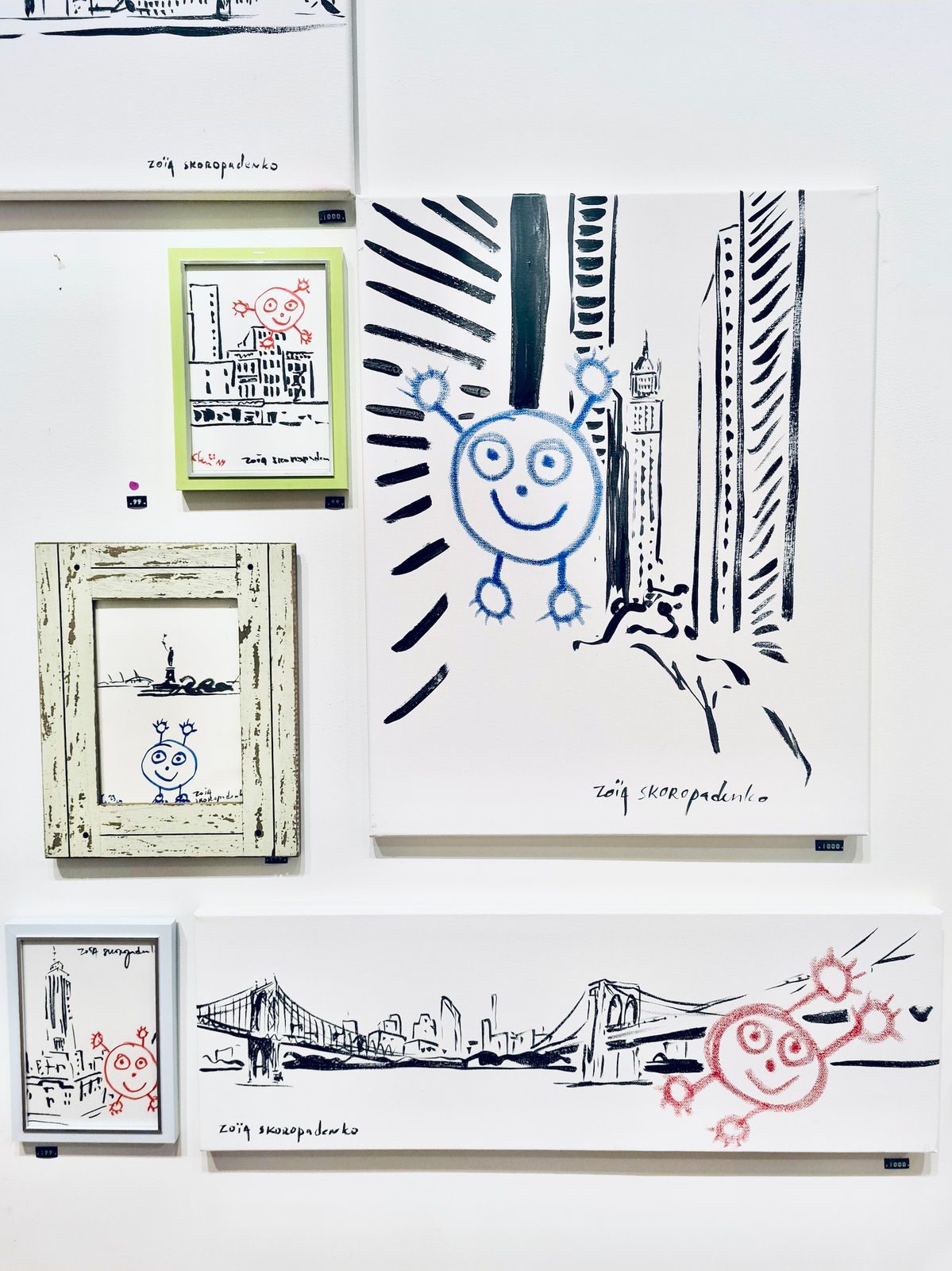 Install view showing a large Blue Boy canvas and smaller framed New York drawings on a white gallery wall